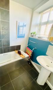 a bathroom with a tub and a sink at St Ives Balcony Flat TreCar in St Ives +47 photos