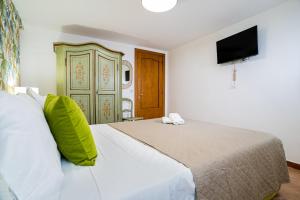 A bed or beds in a room at Casa Carmine - Taormina Centro