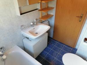 a bathroom with a sink and a toilet at Nandagon Gasthouse 