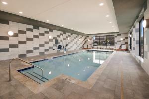a swimming pool in a building with a tile wall at Holiday Inn & Suites - Mt Juliet Nashville Area, an IHG Hotel in Mount Juliet