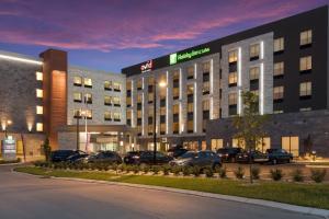 ein Hotelgebäude mit auf einem Parkplatz geparkt in der Unterkunft Holiday Inn & Suites - Mt Juliet Nashville Area, an IHG Hotel in Mount Juliet