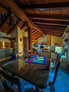 a dining room with a wooden table and chairs at VTAR Casa las Tinajas in Baeza