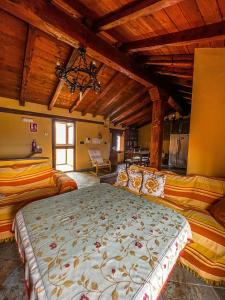 a large bedroom with two beds and a chandelier at VTAR Casa las Tinajas in Baeza