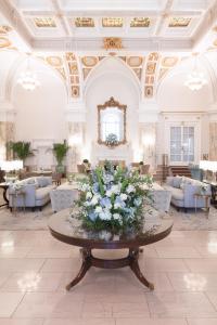 a lobby with a table with flowers on it at The Hermitage Hotel in Nashville