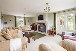 a living room with couches and a fireplace at Tinkers Folly in Harrogate