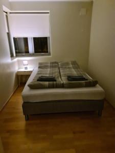 a bed in a small room with a window at Great villa with amazing view in Tromsø