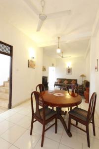 a living room with a wooden table and chairs at N S Apartment in Mount Lavinia