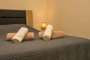 a bed with three rolled towels on top of it at Central Luxury Studio 2 in Korinthos