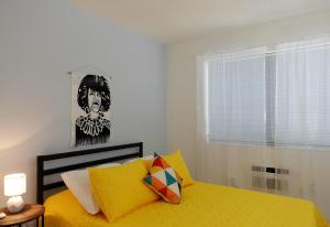 a bedroom with a yellow bed and a window at Miami 1 Bedroom Apt With Parking in Miami