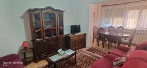 a living room with a couch and a dining room at Apartman "Dom Stankovića" in Pirot