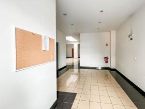 an empty hallway of an office building with a cork board on the wall at Village Lobos Flat in Câmara de Lobos