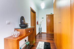 a room with a hallway with wooden floors and a room with a door at Village Lobos Flat in Câmara de Lobos
