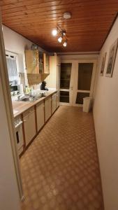 a large kitchen with a wooden ceiling and a hallway at Apartment Silva in Kappel-Grafenhausen