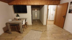 a dining room with a table and a television on the wall at Apartment Silva in Kappel-Grafenhausen