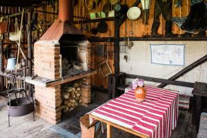 a room with a table and a brick oven at Chalupa Helena na Poráči in Poráč