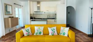 a yellow couch with four pillows on it in a kitchen at Villa Fedelian 2 Playa Blanca in Playa Blanca