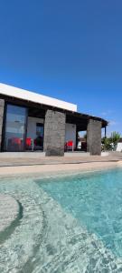 a building with a pool of water in front of it at Villa Fedelian 2 Playa Blanca in Playa Blanca