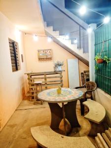 a room with a table and chairs and stairs at Posada MARTINEZ in Corrientes