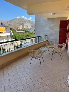 a patio with two chairs and a table on a balcony at 13'S HOME in Caserta