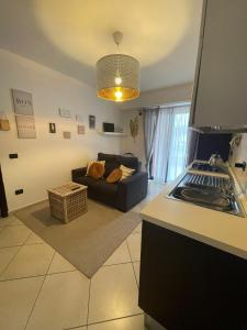 a kitchen and living room with a couch and a table at 13'S HOME in Caserta