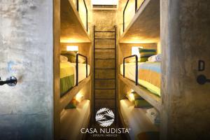 a room with two bunk beds and a ladder at Casa Nudista - LGBT Hotel in Zipolite