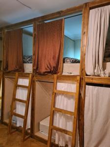 two bunk beds in a room with two ladders at Benevo Hostel in Tbilisi City