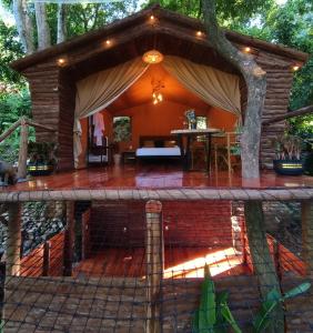 a pavilion with a table on a brick patio at Skala Glamping in Pore