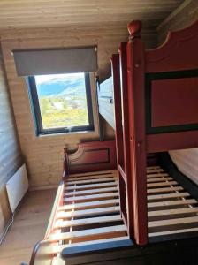 a small room with a bed and a window at Fjellhytte på hardangervidden med uforglemmelig utsikt! in Garden