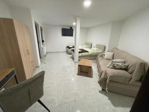 a living room with a couch and a table at Villa Repić in Slatina