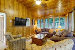 a living room with furniture and a flat screen tv at Stoneybrook Retreat Haven in State Landing