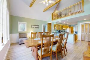 a dining room and kitchen with a wooden table and chairs at Stoneybrook Retreat Haven in State Landing