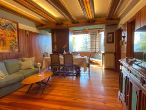 a living room with a couch and a table at Casa Loria - Appartamento con Giardino in San Martino di Castrozza