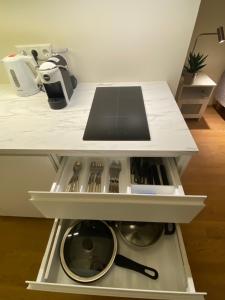 a kitchen with a white counter top with a drawer at Lovely Aisa apartment in Pärnu in Pärnu