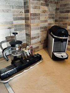 a kitchen counter with a coffee maker and a toaster at Ortansia in Dhimitsana