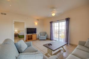 a living room with a couch and a tv and a table at Americana Condos 10th street in Ocean City