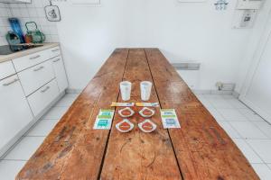 a large wooden table in a kitchen with three oranges at Maison Avocette - Welkeys in Saint-Trojan-les-Bains