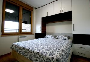 a bedroom with a bed and a window at Apartment Lara in Belgrade