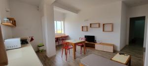 a living room with a table and chairs in a room at Baia Palmeira Residence in Palmeira