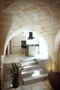 an archway in a room with a staircase in a house at Miro Luxury Home in San Vito dei Normanni