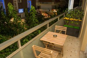 a wooden table and two chairs on a balcony at Central Luxury Studio 2 in Korinthos