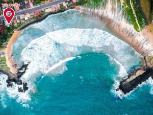 an aerial view of a wave pool on a beach at Villa One64 Beach Front - Apartments in Hikkaduwa