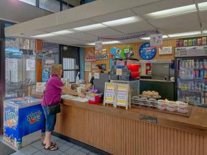 a woman standing at a counter in a store at Sidney James Mountain Lodge in Gatlinburg