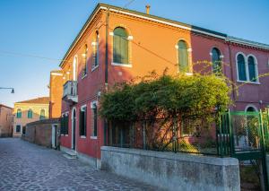 Une rangée de maisons colorées dans une rue dans l'établissement Beocio Home • The hidden gem in Murano’s heart, à Murano