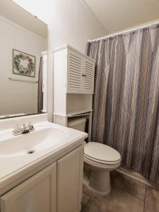 a white bathroom with a toilet and a sink at Myrtle Beach Resort A532 in Myrtle Beach