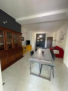 a large living room with a table and chairs at Terrace house appartamento mq 80 adiacente ospedale e clinica in Piacenza