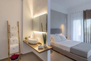 una camera da letto con un grande letto bianco e un lavandino di Vivianna's View ad Azólimnos