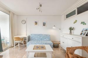 a living room with a couch and a table at Flamingo Apartment on the south near the beach in Palm-mar