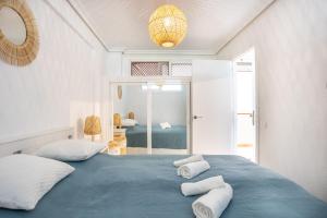 a bedroom with a blue bed with white pillows at Flamingo Apartment on the south near the beach in Palm-mar