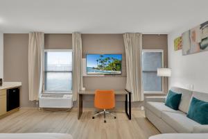 a living room with a desk and a couch at Comfort Inn in South Padre Island