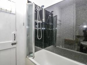 a shower with a glass door in a bathroom at Homely 4 Bedroom large house inc FREE Parking - Great Location - Fast WiFi - Smart TV - sleeps up to 7! Close to Bournemouth & Poole Town Centre & Sandbanks in Bournemouth